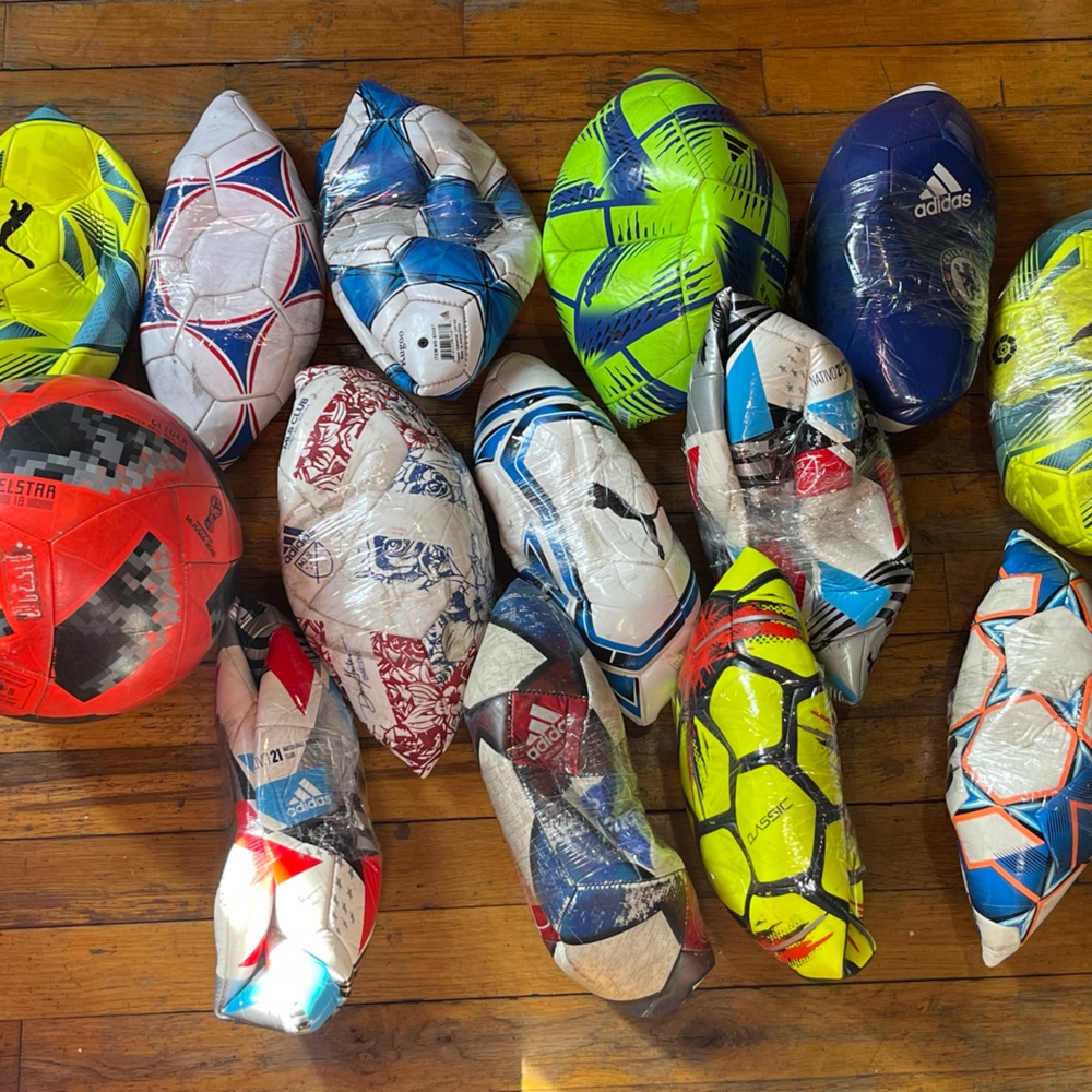 Lot of 14 used soccer balls.